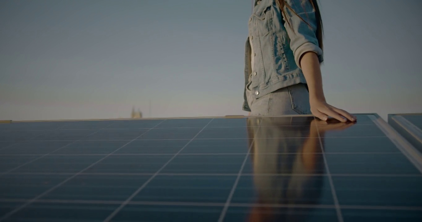女人边走边触摸太阳能电池板