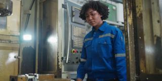 非裔美国技术员女工程师在工厂制造业，工业工程师咨询讨论在数控铣床安装过程中提高加工质量和工程零件的自动穿线操作。