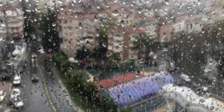 雨点在雨天城市景观窗玻璃上的时间流逝。