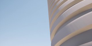 圆形建筑由混凝土组成的未来主义现代建筑建筑清澈蓝天4k
