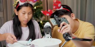 圣诞节期间，亚洲孩子们在家里拍摄饼干烹饪视频制作病毒视频，或者在家里一起拍TikTok，这是新一代概念的时尚生活方式。