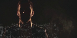 4k慢动作视频男性的脸在阴影，烟雾和数学。
