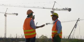 测量师、建造师、工程师、技术人员在新工地讨论施工计划。