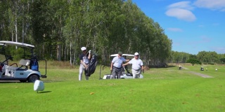 一群亚洲人在乡村俱乐部打高尔夫球。