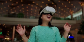 激动人心的亚洲女性穿着vr耳机使用VR-headset眼镜走过metaverse得到体验的虚拟百货商场,亚洲女性享受虚拟现实眼镜虚拟购物