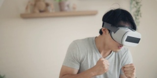 亚洲男子玩虚拟现实游戏元宇宙数字世界技术AR增强现实控制