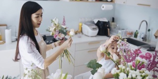 亚洲华人女性花商和女儿插花。每天早上经营小生意的例行公事和家庭团聚的时间