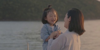 带着两个孩子的亚洲家庭乘船游玩。