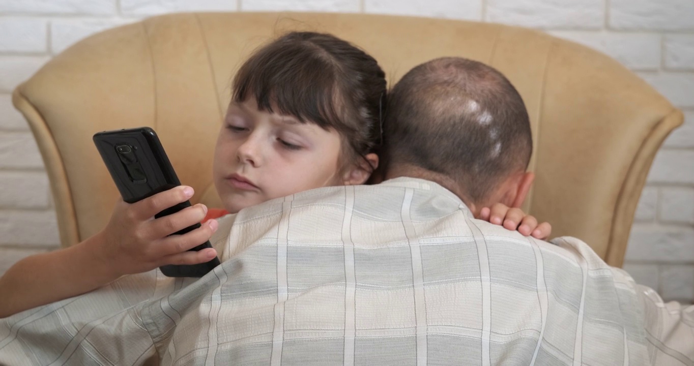 父亲和女儿用智能手机。