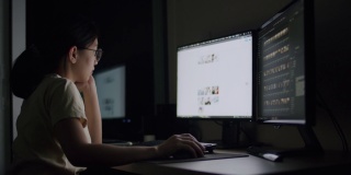 坦率的亚洲女性工作到深夜，在家庭办公室的电脑上压力一个问题。
