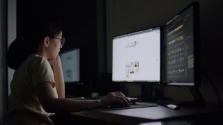 坦率的亚洲女性工作到深夜，在家庭办公室的电脑上压力一个问题。视频素材模板下载