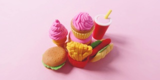 各种快餐特写的微缩模型。人类的手在明亮的粉红色背景上铺上美国快餐的小型玩具。4k延时搞笑微距视频。
