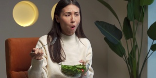 不开心的亚洲女性在节食，不喜欢吃健康的食物和蔬菜