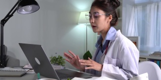 年轻漂亮的亚洲女医生在医务室，与病人进行在线会诊。年轻女医生用听诊器进行视频通话