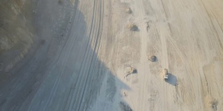 用挖掘机和自卸卡车露天开采建筑用石灰石材料的鸟瞰图