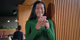 在候机室等待下机的时候，亚裔现代女性使用手机