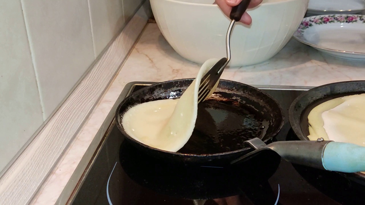 做煎饼。铸铁煎锅上的传统俄罗斯布林。