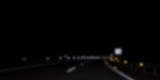 模糊离焦的汽车在高速公路夜间行驶的POV散焦图像