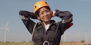 在风力发电厂穿着防护服的亚洲女工程师