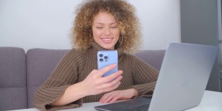 快乐的女人用手机上网。开朗的白人女性使用现代智能手机，露出露齿的微笑。自由职业者用新手机上网交流