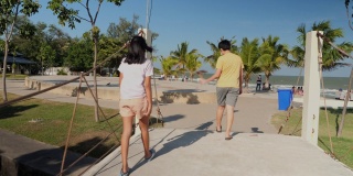 亚洲儿童在阳光明媚的日子里一起走向海滩，生活方式的理念。
