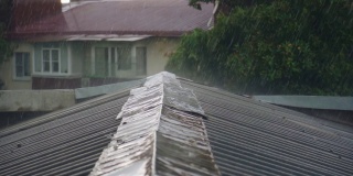 雨滴落在屋顶上的特写镜头。用慢镜头拍摄倾盆大雨