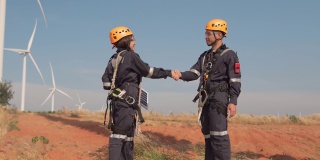 在泰国风电场，两名亚洲工程师在统一的检查工程师准备和进度检查风力发电机的安全。