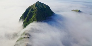 非常棒的航拍全景。高高的绿色山脊周围覆盖着浓密的白云