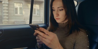 女性在车内使用手机短信滚动浏览互联网搜索新闻