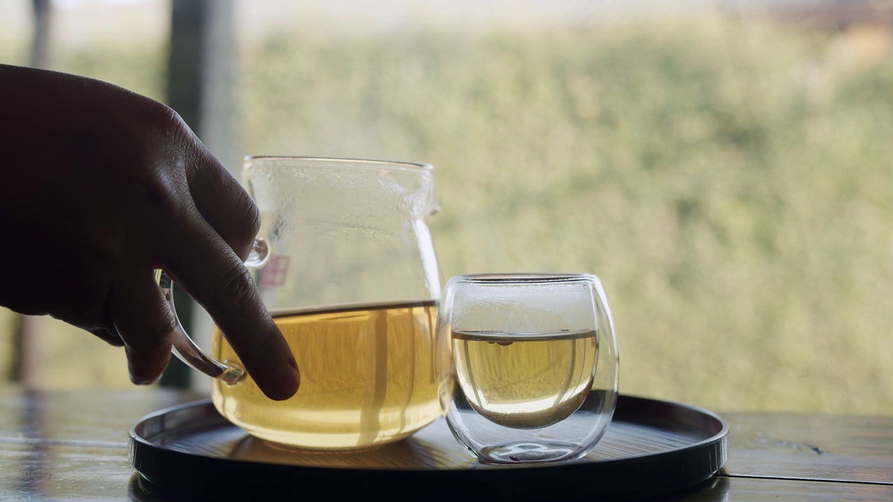 透明的茶壶和带烟的杯子，热气腾腾的茶，富含抗氧化剂的健康中国茶