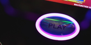 在赌场会所的赌博老虎机上，手按按钮或旋转按钮