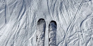 滑雪者的滑雪板在移动的椅子升降机越过斜坡。