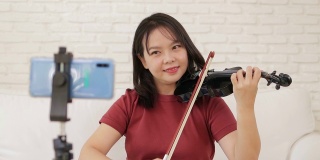 亚洲女教师在家教学生如何演奏古典乐器小提琴