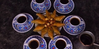 桌上有土耳其咖啡和果仁蜜饼。有选择性的重点。食物。