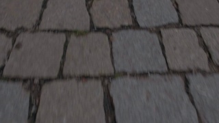 在旧城中铺路石在行人脚下的快速移动。视频素材模板下载