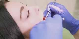 牙医使用医疗器械检查病人的口腔