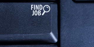 人的手指按下电脑键盘上的“找工作”按钮的特写