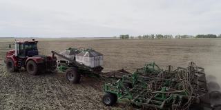 工业机器在农田上的农业工作的无人机视图