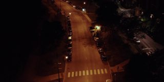 无人机拍摄到一辆汽车深夜在芝加哥昏暗的郊区行驶。