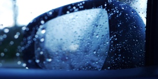 在雨中通过后视镜在市区行驶