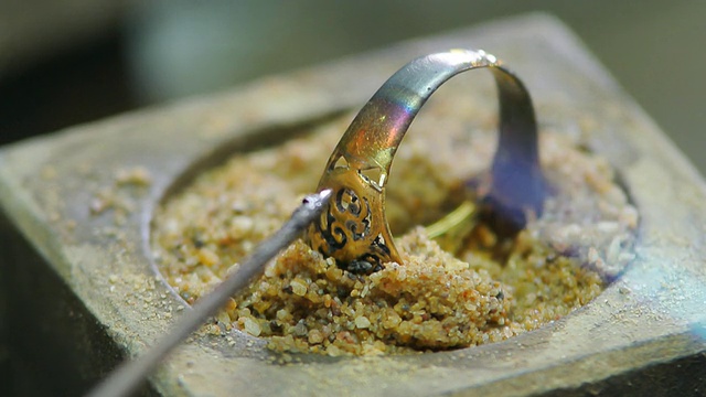 Goldsmith working with a unfinished ring