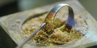 Goldsmith working with a unfinished ring