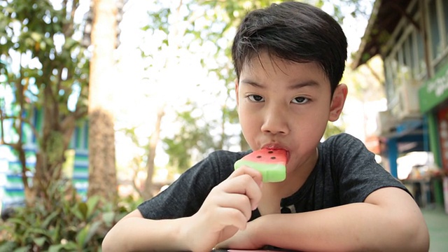 Little Asian boy enjoy with icecream .