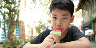 Little Asian boy enjoy with icecream .
