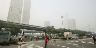 中国北京，2014年10月25日:在恶劣的天气下，中国北京国贸CBD的标志性建筑远处一片朦胧