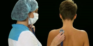 医生用听诊器在阿尔法通道上听一位女病人检查肺部