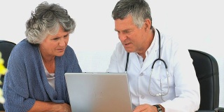 医生和病人一起看笔记本电脑