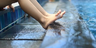 foot on the edge of swimming pool