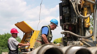 两名石油工人在钻井平台上工作视频素材模板下载