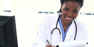 黑人女医生在写字板上写字